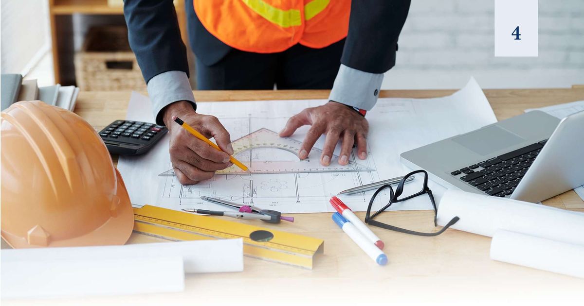 Engineer reviewing blueprints on site