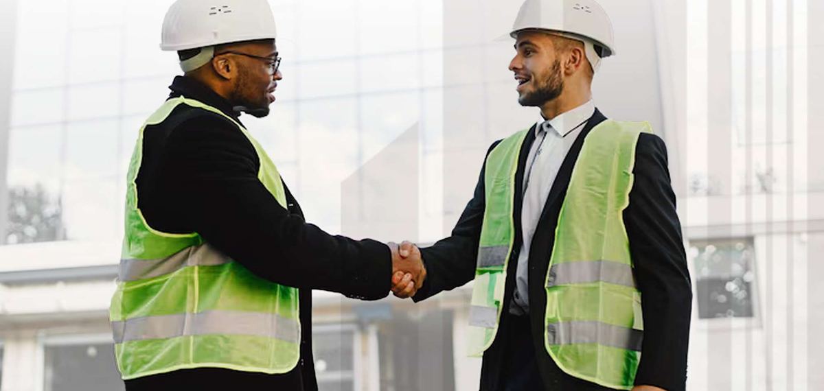 Two construction professionals shaking hands